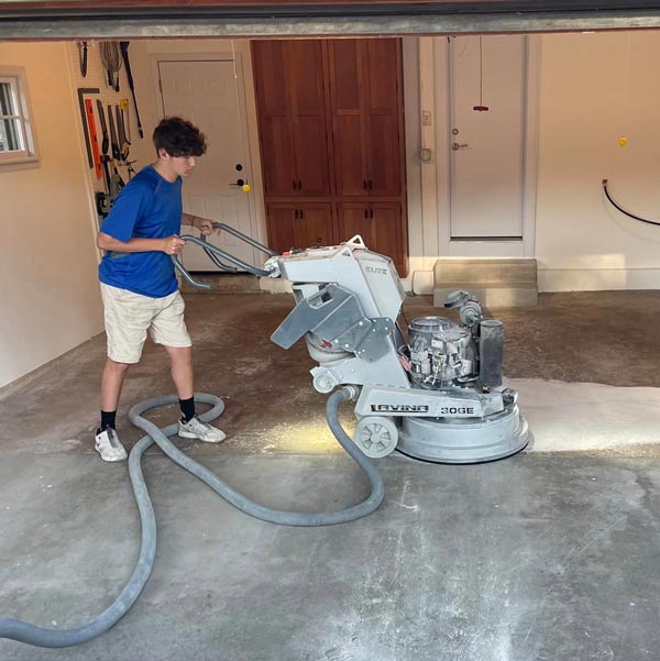 Ryan prepping floor with grinder